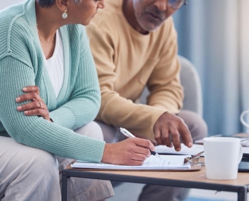 Senior couple, documents and sign contract for life insurance or home mortgage. Discussion, signature and retired elderly man and woman signing legal paperwork for will or loan application together.