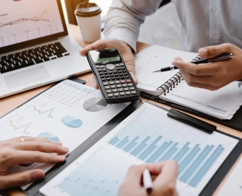 team working together through finance spreadsheets
