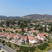 Aerial view of middle class neighborhood with residential house community and mountain on the background in Rancho Bernardo, South California, USA.