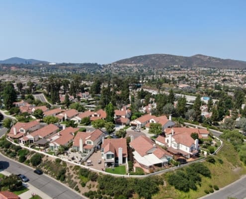 Aerial view of middle class neighborhood with residential house community and mountain on the background in Rancho Bernardo, South California, USA.