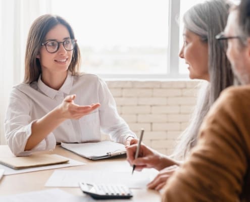 Insurance agent lawyer financial advisor broker discussing consulting mature middle-aged couple signing contract documents, buying property, investments at home