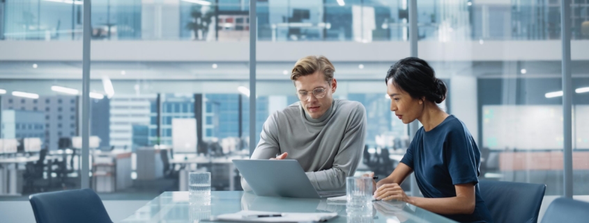 Multiethnic Diverse Office Conference Room Meeting: Team of Two Creative Entrepreneurs Talk, Discuss Growth Strategy. Stylish Young Businesspeople work on Investment and Marketing Projects.