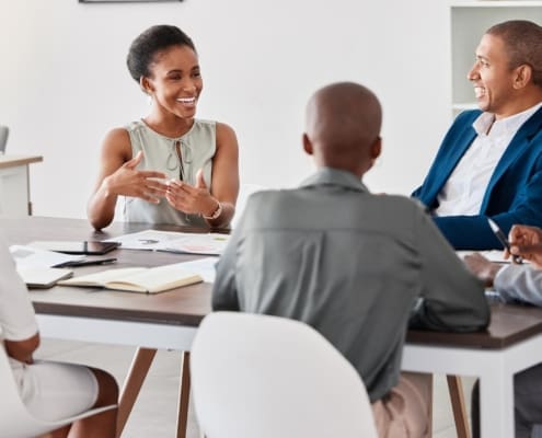 Meeting, planning and strategy of business woman, team leader or manager talking of KPI goal, mission or finance growth development. Brainstorming ideas and listening group for about us or our vision