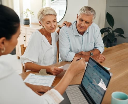 Financial advisor consultation with clients on retirement, finance planning or investment and document on laptop screen. Accountant woman, senior people and pension advice, asset management or budget