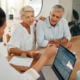 Financial advisor consultation with clients on retirement, finance planning or investment and document on laptop screen. Accountant woman, senior people and pension advice, asset management or budget