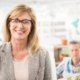 Portrait of smiling casual businesswoman in front of her colleague in the office