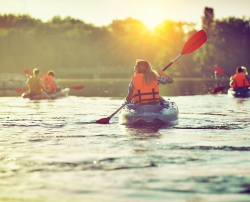Kayaking and canoeing with family. Children on canoe. Family on kayak ride.