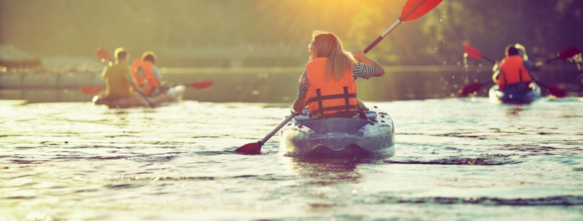 Kayaking and canoeing with family. Children on canoe. Family on kayak ride.