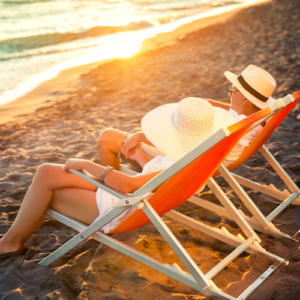 Happy couple enjoy sunset on the beach during summer vacations