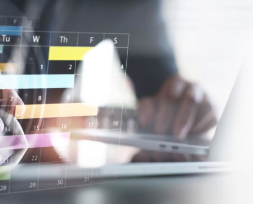 Close up of businessman using digital tablet with calendar planner and organizer to plan and reminder daily appointment, meeting agenda, schedule, timetable, and management, event planning